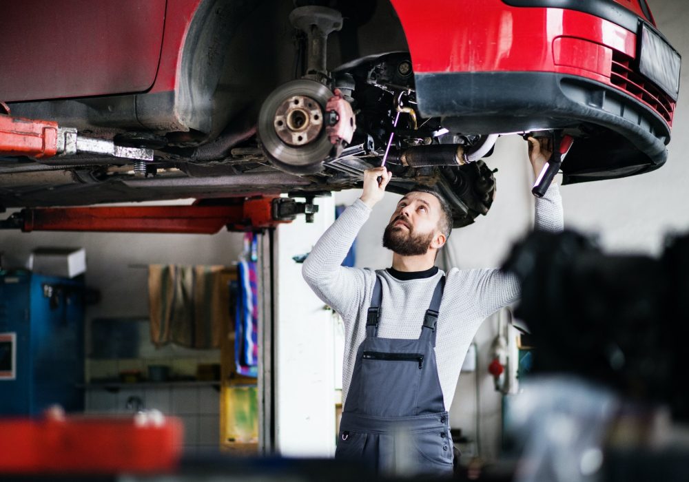 man-mechanic-repairing-a-car-in-a-garage-1-1.jpg